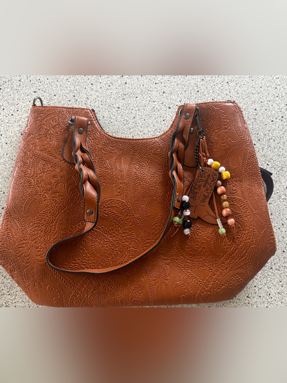 Embossed Brown Shoulder Bag with Braided Straps and Beaded Charm